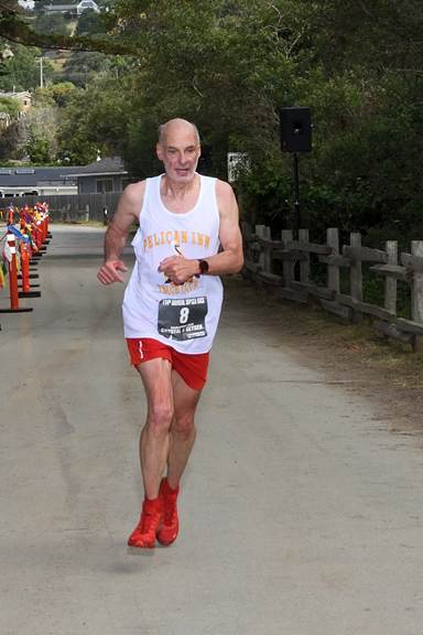 Mark Tatum crossing the finish line in second place